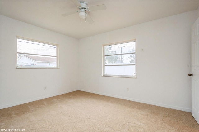 carpeted spare room with ceiling fan