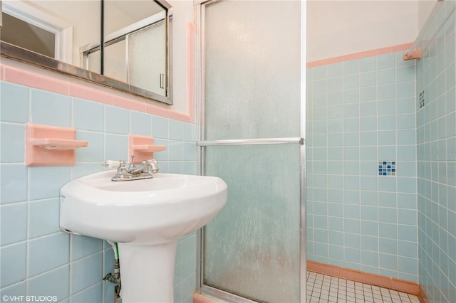 bathroom featuring tile walls and walk in shower