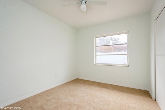 empty room with light carpet and ceiling fan