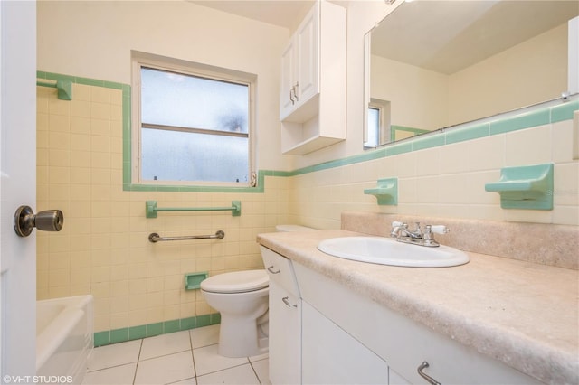 bathroom with tile patterned flooring, vanity, toilet, and tile walls