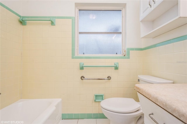 bathroom with vanity, toilet, and tile walls