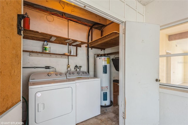 clothes washing area with washer and clothes dryer and water heater