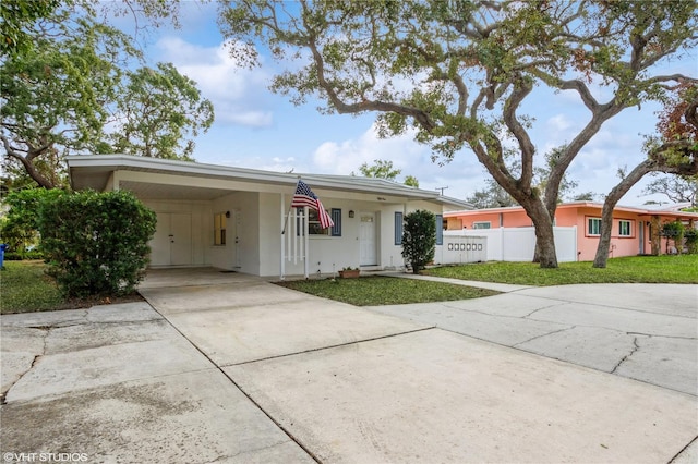 single story home with a front yard and a carport