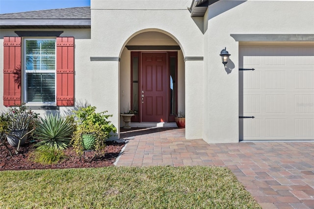 view of exterior entry featuring a garage