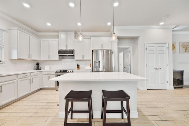 kitchen featuring light stone countertops, white cabinetry, pendant lighting, and appliances with stainless steel finishes