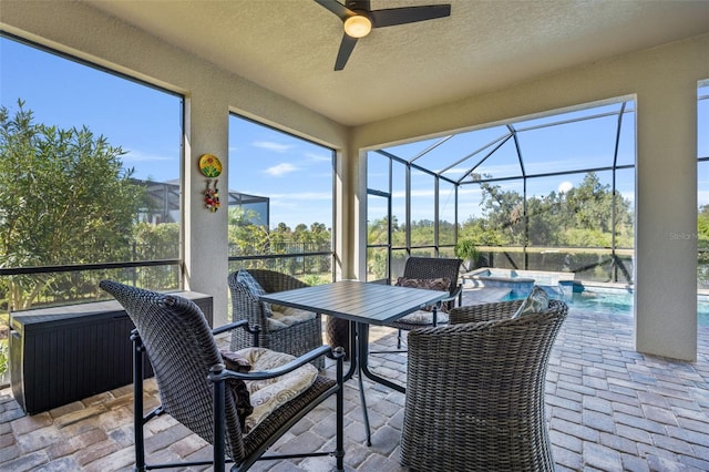 sunroom / solarium featuring ceiling fan