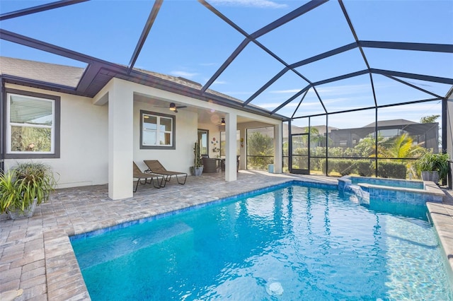 view of pool featuring an in ground hot tub, a patio area, ceiling fan, and a lanai