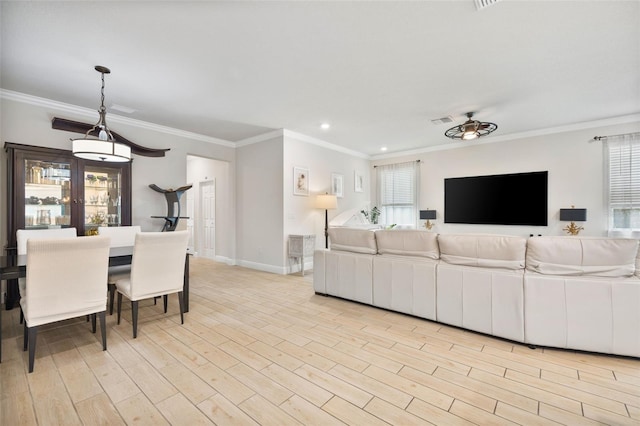 living room with ceiling fan, light hardwood / wood-style floors, and crown molding