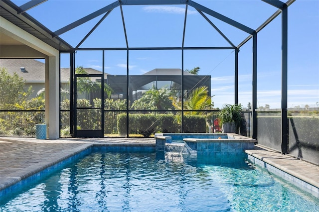 view of swimming pool featuring a patio area, an in ground hot tub, and glass enclosure