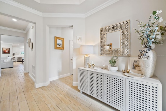 hallway featuring crown molding and light hardwood / wood-style floors