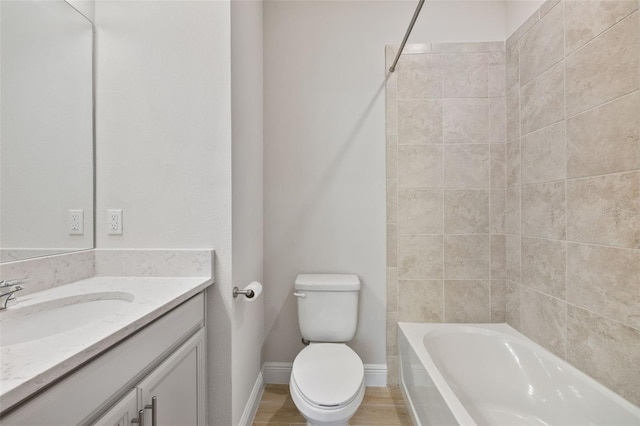 full bathroom with vanity, hardwood / wood-style flooring, shower / washtub combination, and toilet