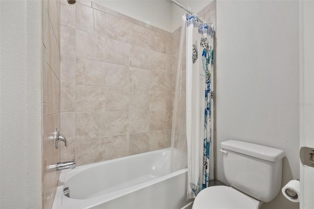 bathroom featuring shower / bathtub combination with curtain and toilet