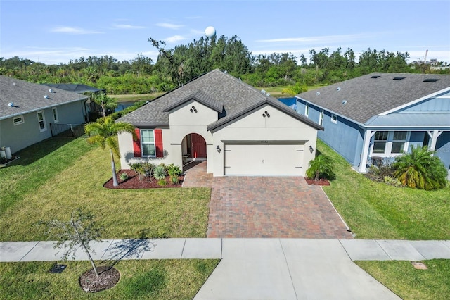 ranch-style home with a garage and a front lawn