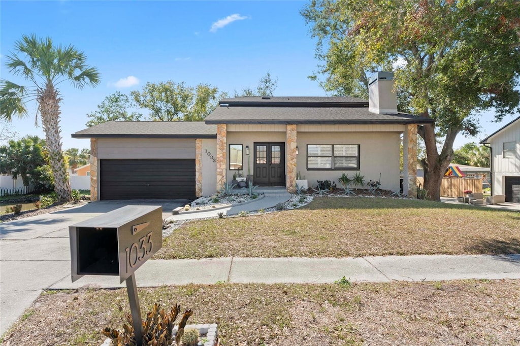 view of front of home with a garage and a front yard