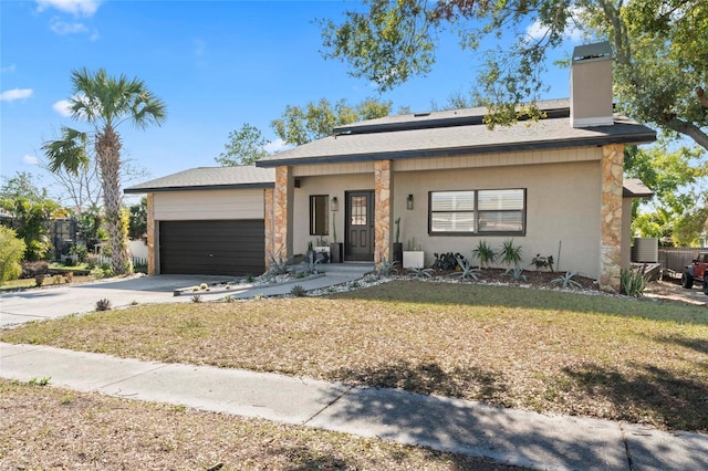 view of front of property with a garage and a front yard