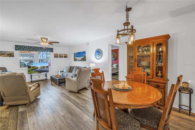 8174 Terrace Garden Dr N Unit 110, Saint Petersburg, FL 33709 - dining area featuring a ceiling fan and wood finished floors