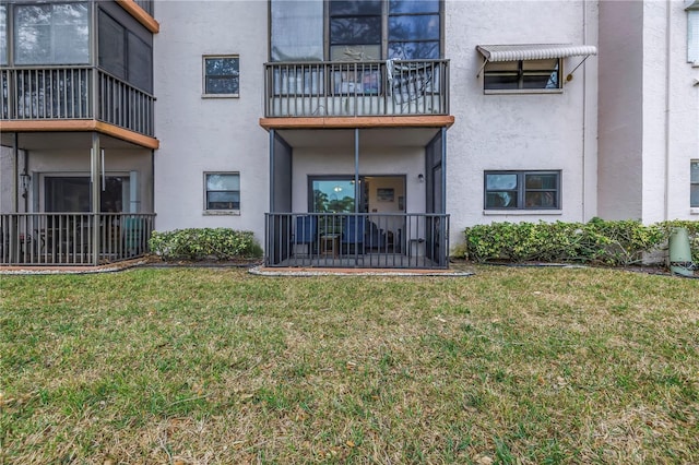 8174 Terrace Garden Dr N Unit 110, Saint Petersburg, FL 33709 - rear view of house with stucco siding and a yard