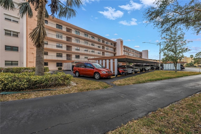 8174 Terrace Garden Dr N Unit 110, Saint Petersburg, FL 33709 - view of property featuring covered and uncovered parking