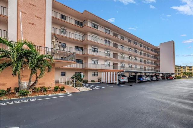 8174 Terrace Garden Dr N Unit 110, Saint Petersburg, FL 33709 - view of apartment building / complex with covered parking