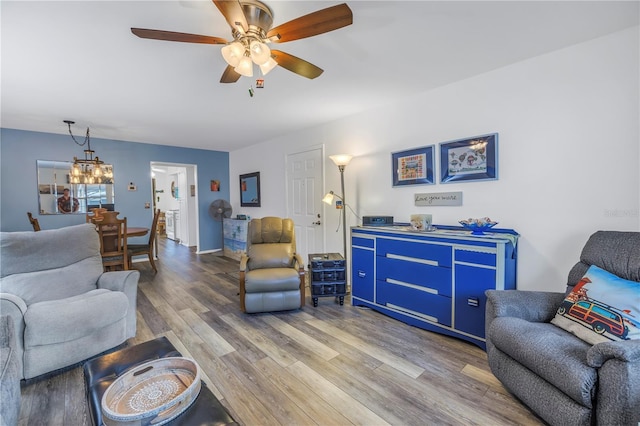 8174 Terrace Garden Dr N Unit 110, Saint Petersburg, FL 33709 - living room with wood finished floors, ceiling fan, and a chandelier