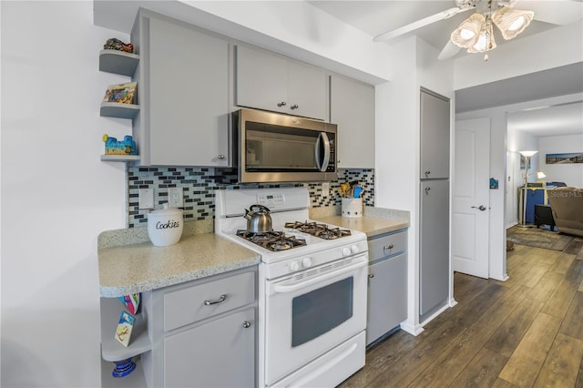 8174 Terrace Garden Dr N Unit 110, Saint Petersburg, FL 33709 - kitchen with stainless steel microwave, white range with gas cooktop, open shelves, and gray cabinets