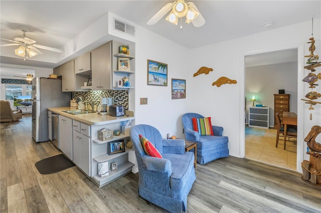 8174 Terrace Garden Dr N Unit 110, Saint Petersburg, FL 33709 - kitchen with open shelves, ceiling fan, and light countertops