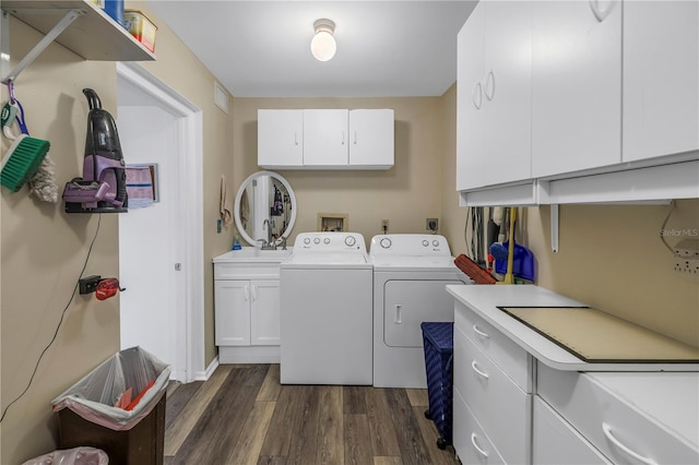 8174 Terrace Garden Dr N Unit 110, Saint Petersburg, FL 33709 - washroom featuring cabinet space, washing machine and dryer, and dark wood-style flooring