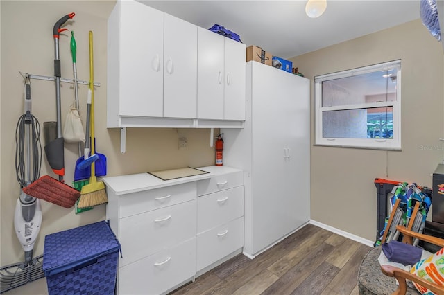 8174 Terrace Garden Dr N Unit 110, Saint Petersburg, FL 33709 - kitchen with dark wood finished floors, light countertops, and white cabinetry