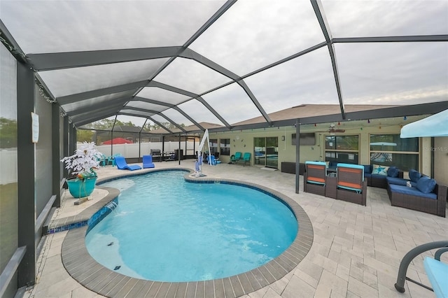 view of swimming pool with pool water feature, an outdoor living space, a lanai, and a patio