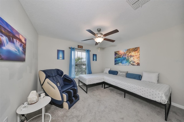 interior space featuring a textured ceiling, ceiling fan, and light carpet