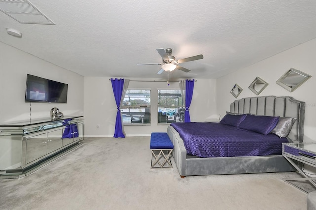 bedroom featuring carpet, a textured ceiling, and ceiling fan