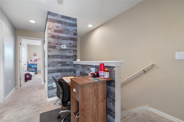 office with carpet flooring and wood walls