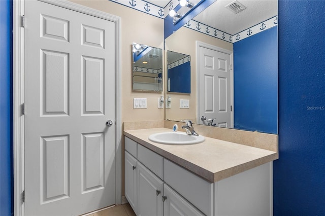 bathroom featuring tile patterned floors and vanity