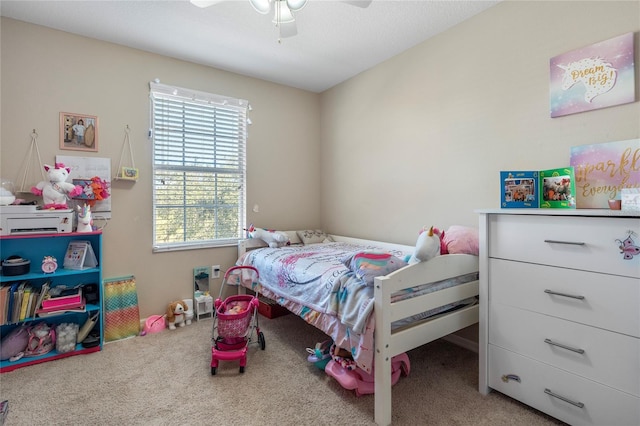 bedroom with ceiling fan and light carpet