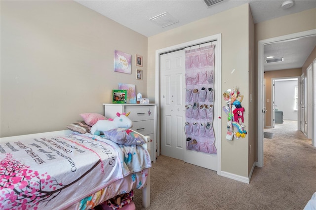 bedroom featuring light carpet and a closet