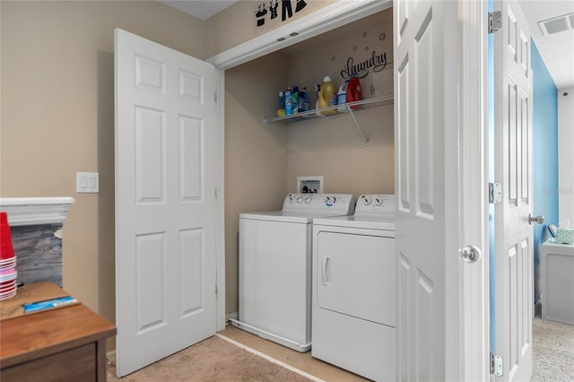 washroom with washing machine and dryer and light colored carpet