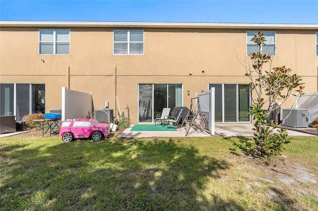 rear view of property with ac unit, a yard, central AC, and a patio area