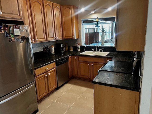 kitchen with light tile patterned flooring, backsplash, stainless steel appliances, and sink