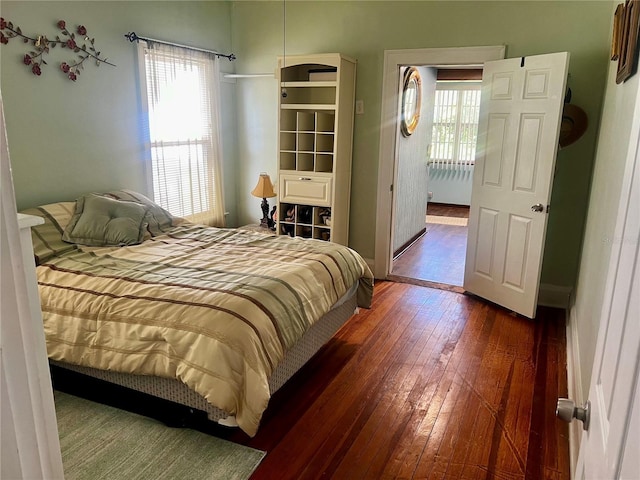 bedroom with radiator and dark hardwood / wood-style flooring