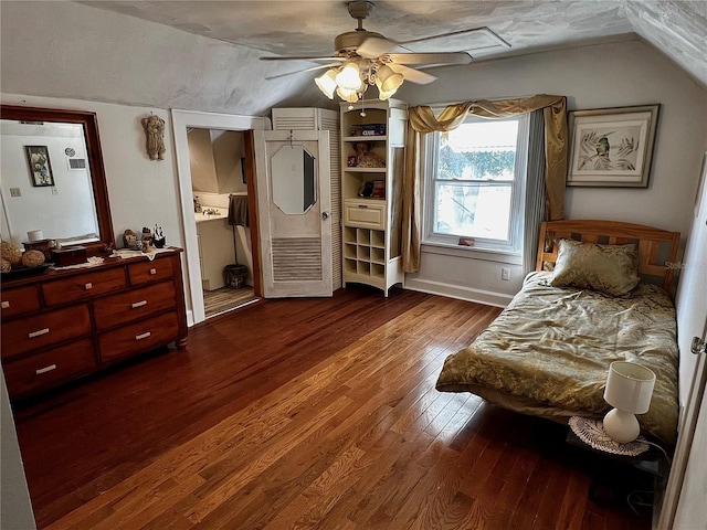 bedroom with ceiling fan, ensuite bathroom, vaulted ceiling, and hardwood / wood-style flooring