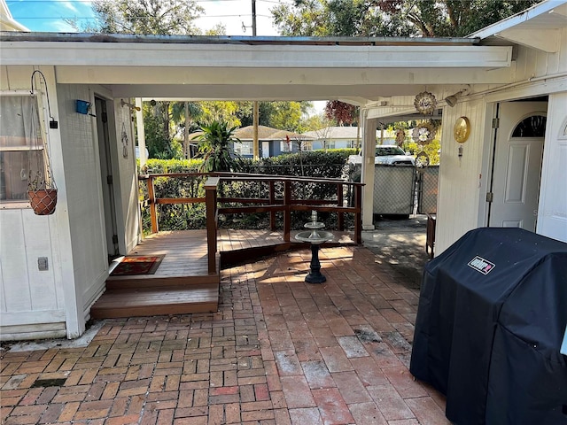 view of patio with a deck and a grill