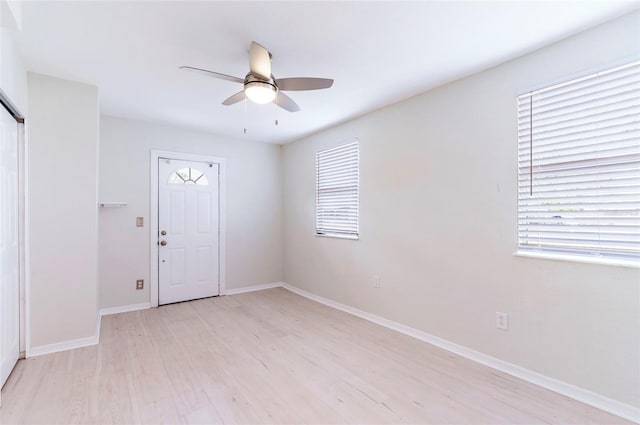 empty room with light hardwood / wood-style flooring and ceiling fan