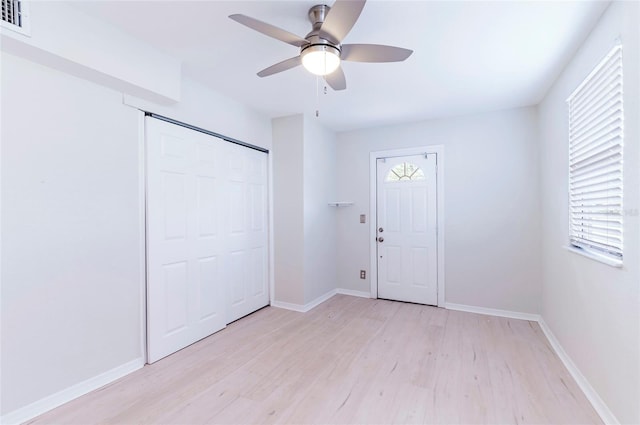 unfurnished bedroom featuring a closet, ceiling fan, and light wood-type flooring