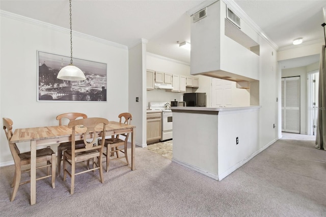 kitchen featuring pendant lighting, light carpet, black refrigerator, kitchen peninsula, and range