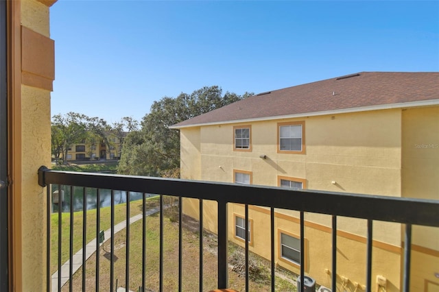 balcony featuring a water view and central AC unit