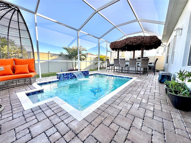 view of swimming pool with an outdoor living space, an outdoor bar, pool water feature, a lanai, and a patio