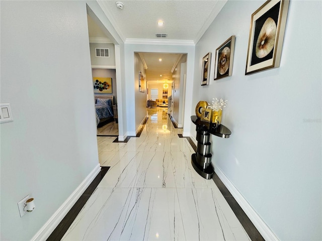 hall featuring ornamental molding and a textured ceiling