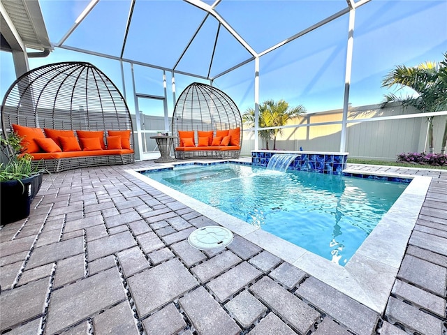 view of swimming pool featuring glass enclosure, pool water feature, and a patio