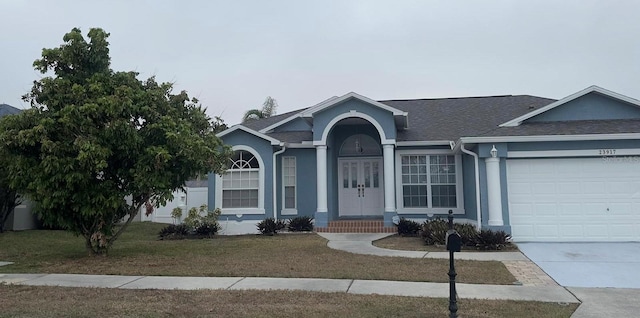 ranch-style house with a front lawn and a garage