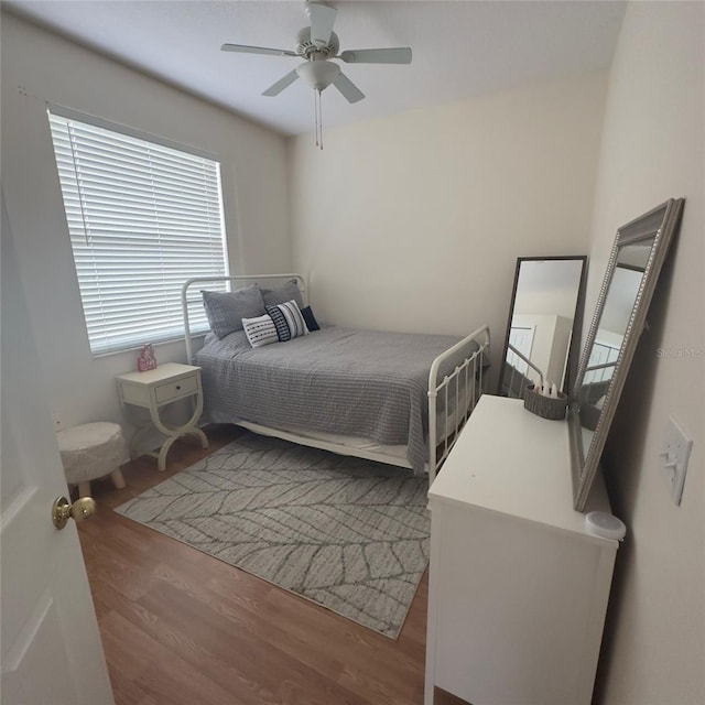 bedroom with ceiling fan and wood-type flooring